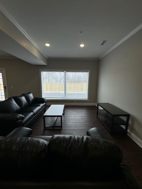 Cozy living area with hardwood-style floors and white trim