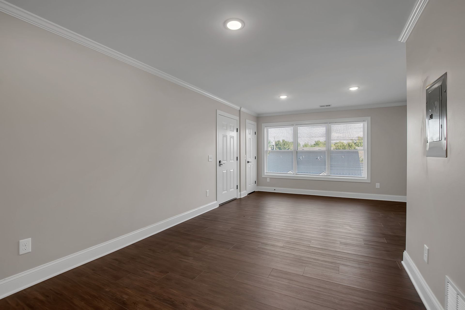 Sitting area inside apartment unit with updated flooring finish