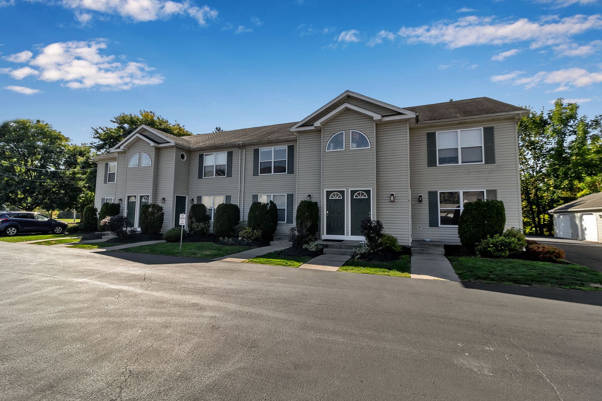 Exterior angle of apartment buildings with paved walkways and greenery