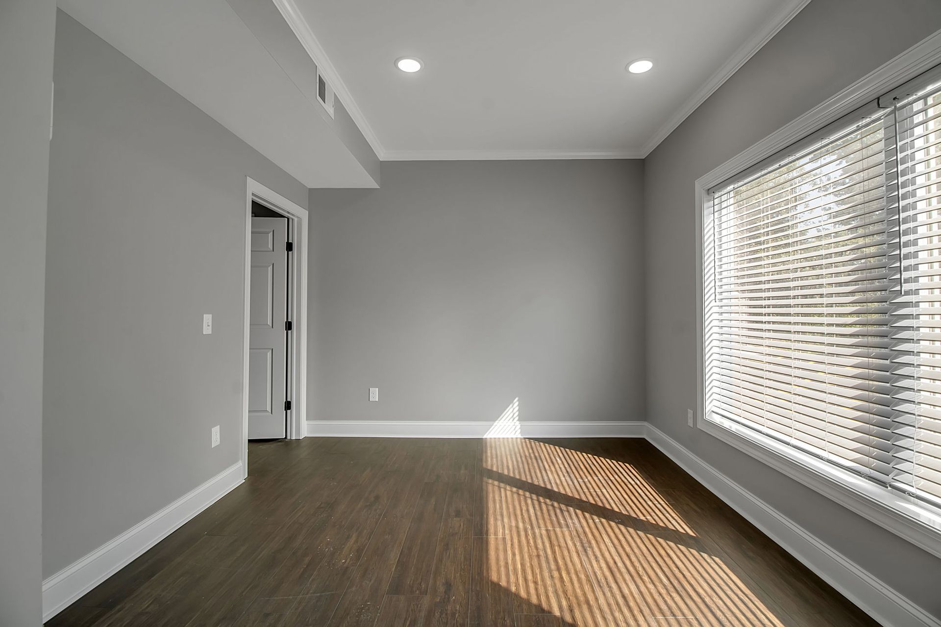 Living room interior with updated flooring and architectural trim
