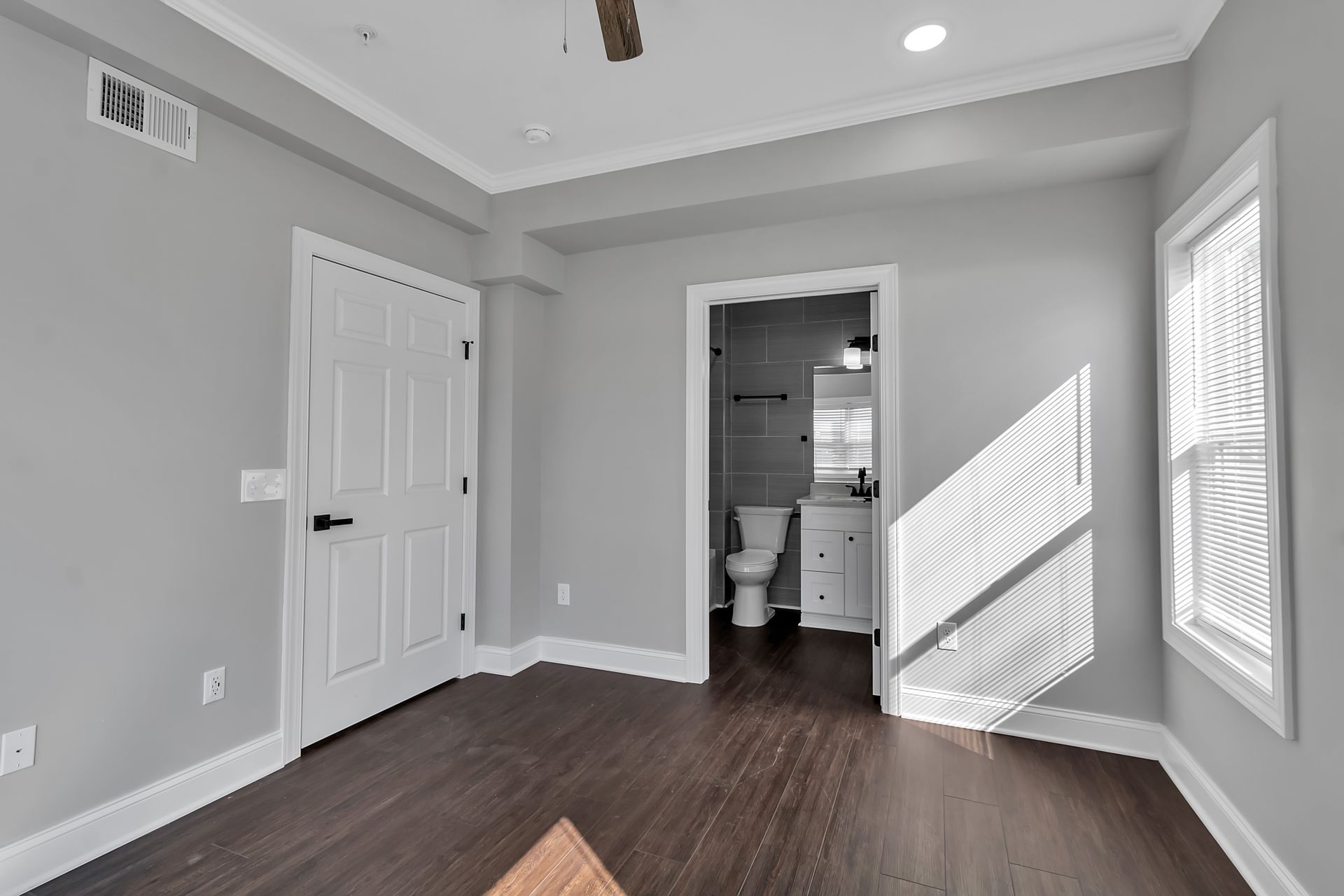 Bedroom interior with open floor arrangement and neutral tones