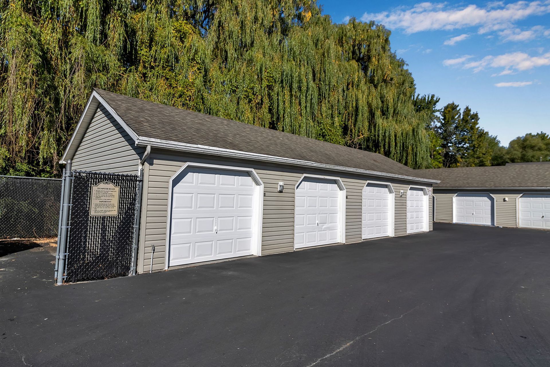 Detached garage units with paved parking area at Wyse Properties apartment community in Amherst NY