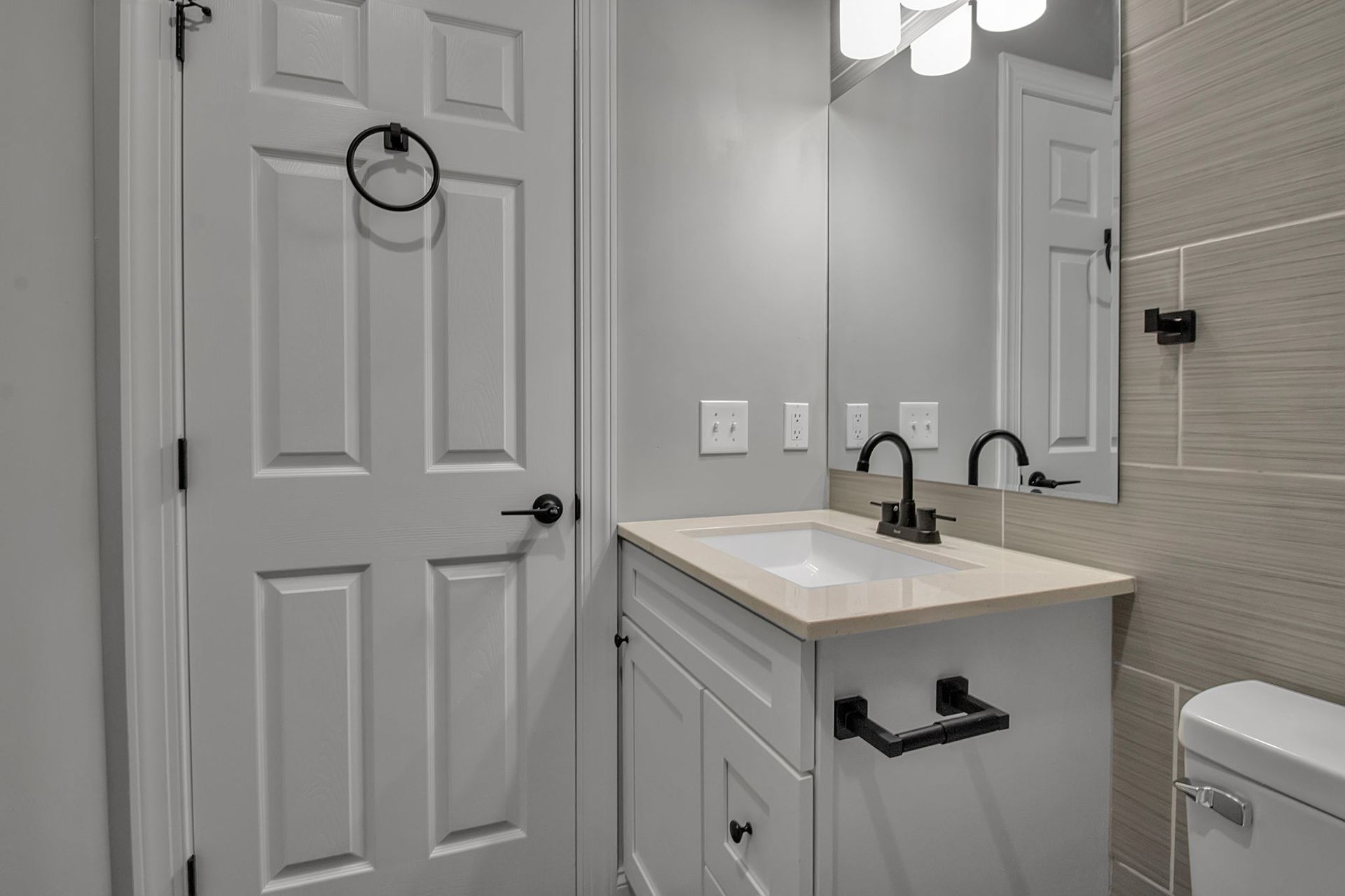 Bathroom interior with polished tile and sink hardware