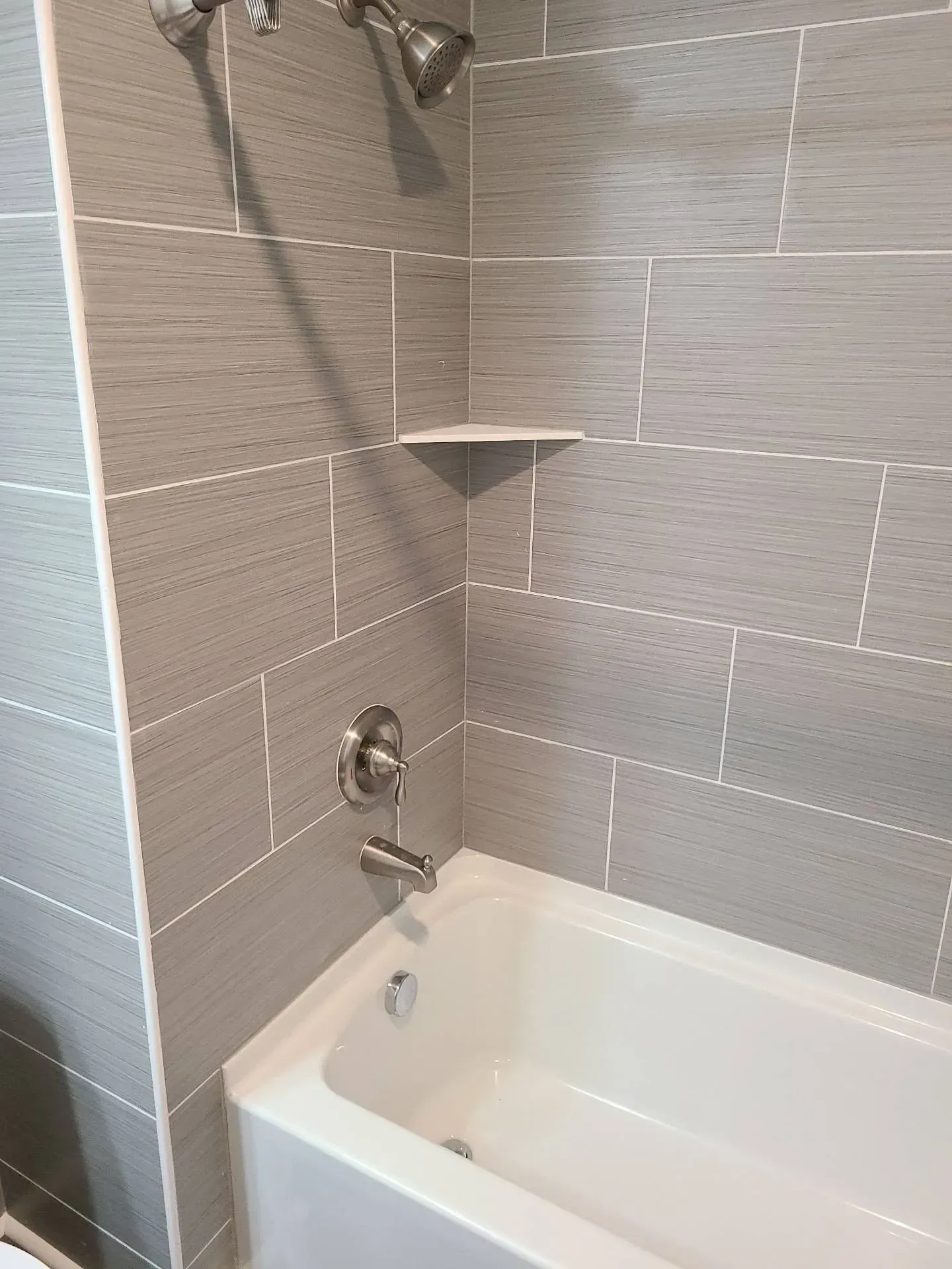 A bathroom with a bathtub and a shower.