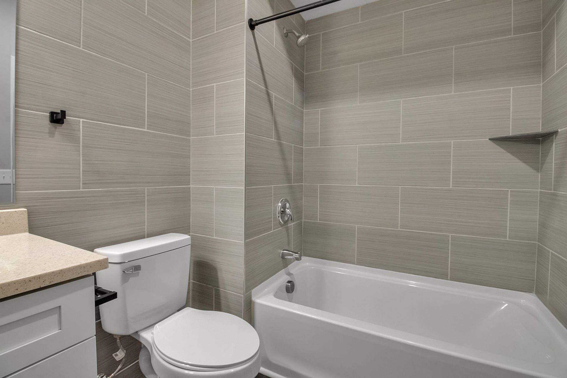 Bathroom environment with sleek vanity design and tile finish