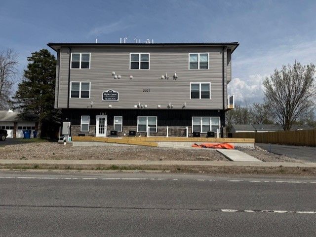 Modern apartment property with neutral siding and trim accents