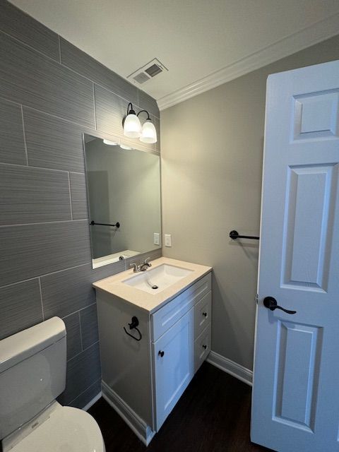Bathroom space with sleek vanity installation and tile surfaces