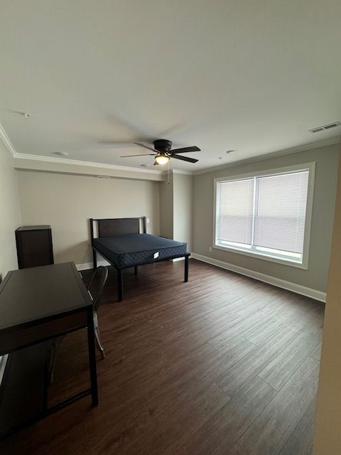 Apartment bedroom with wide floor space and neutral wall finish