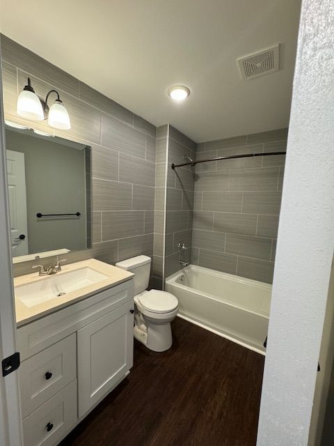 Washroom interior with modern sink hardware and tile wall