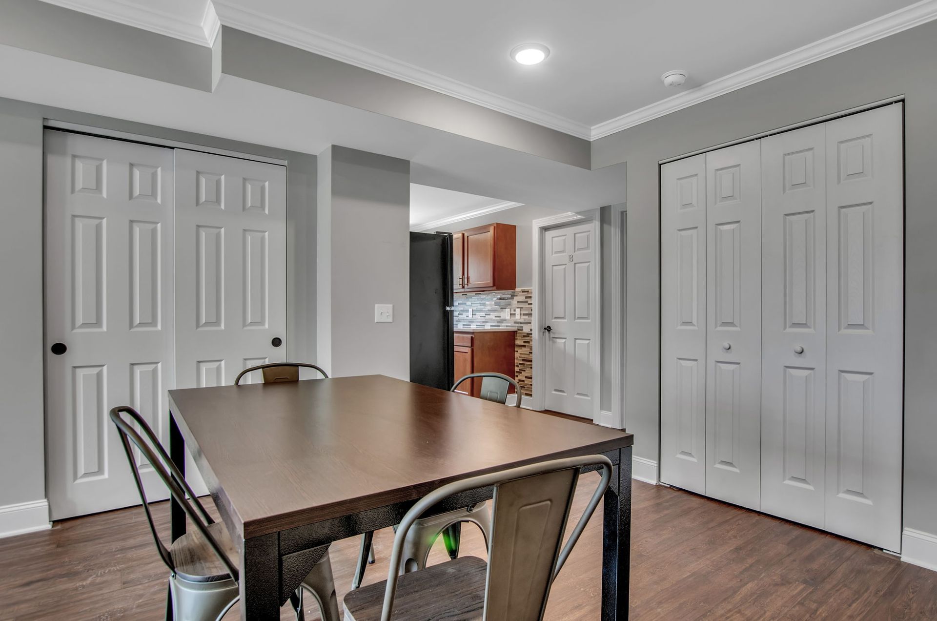 A dining room with a table and chairs in a basement.