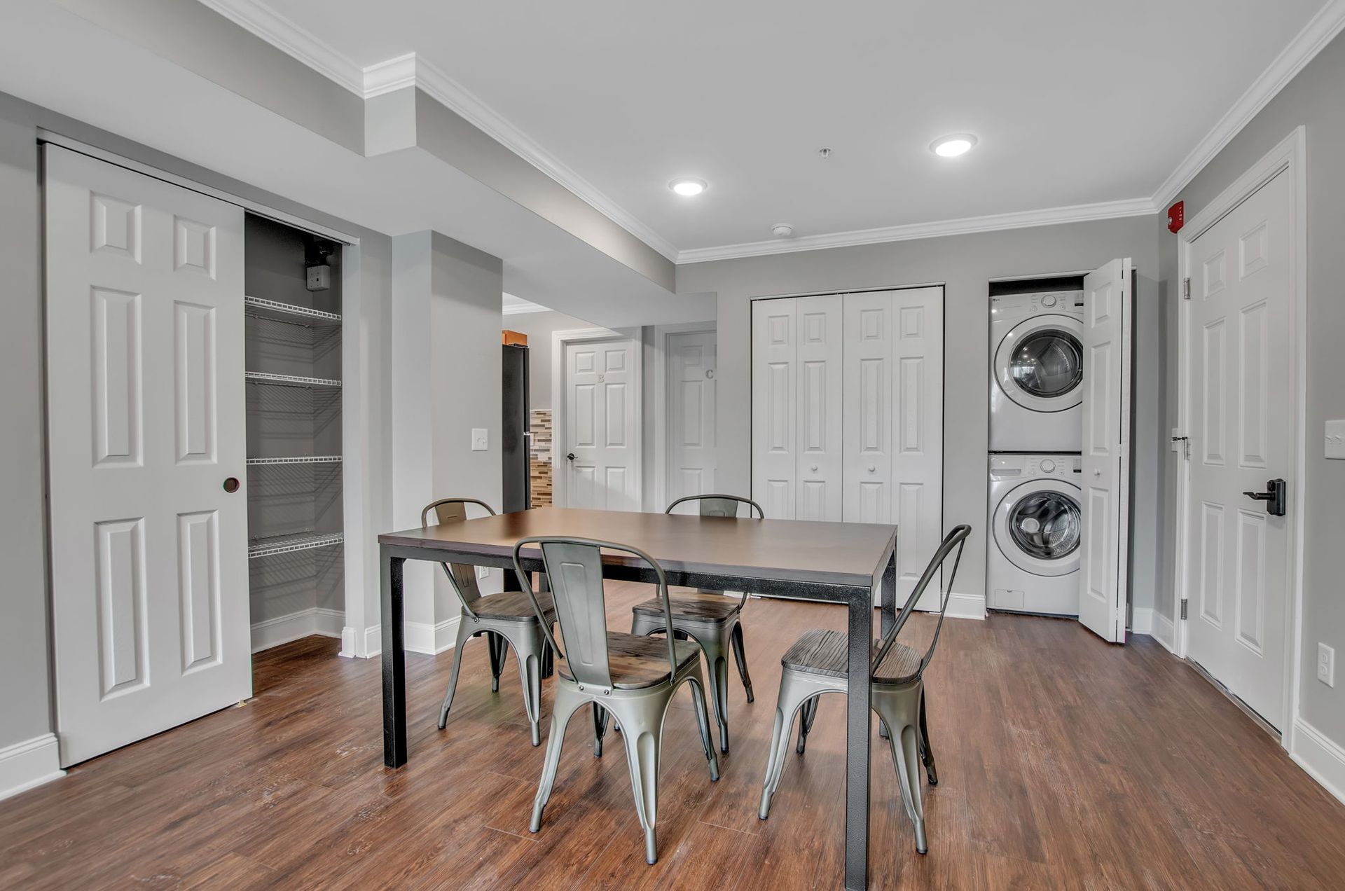 There is a table and chairs in the middle of the room.
