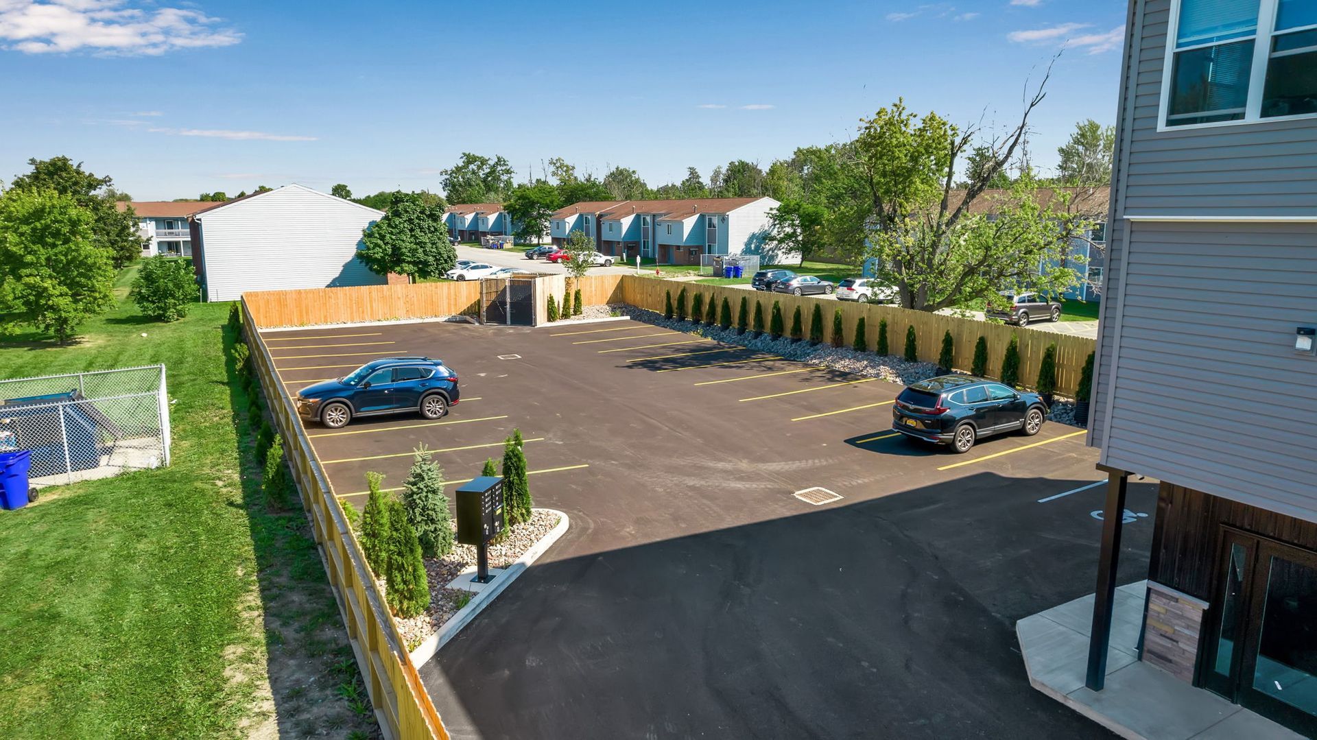 An aerial view of a parking lot with cars parked in it.