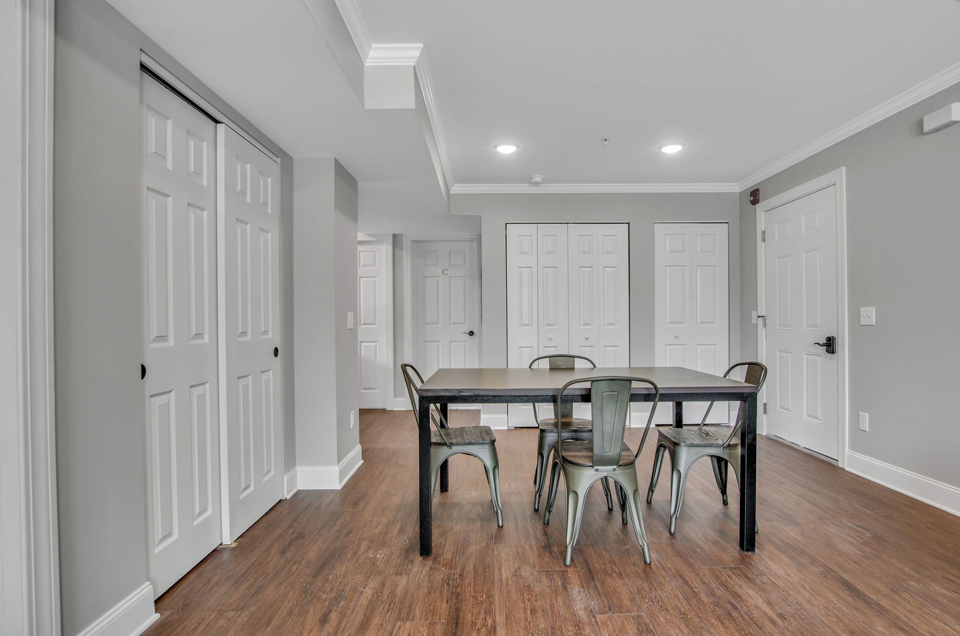 A dining room with a table and chairs in a basement.
