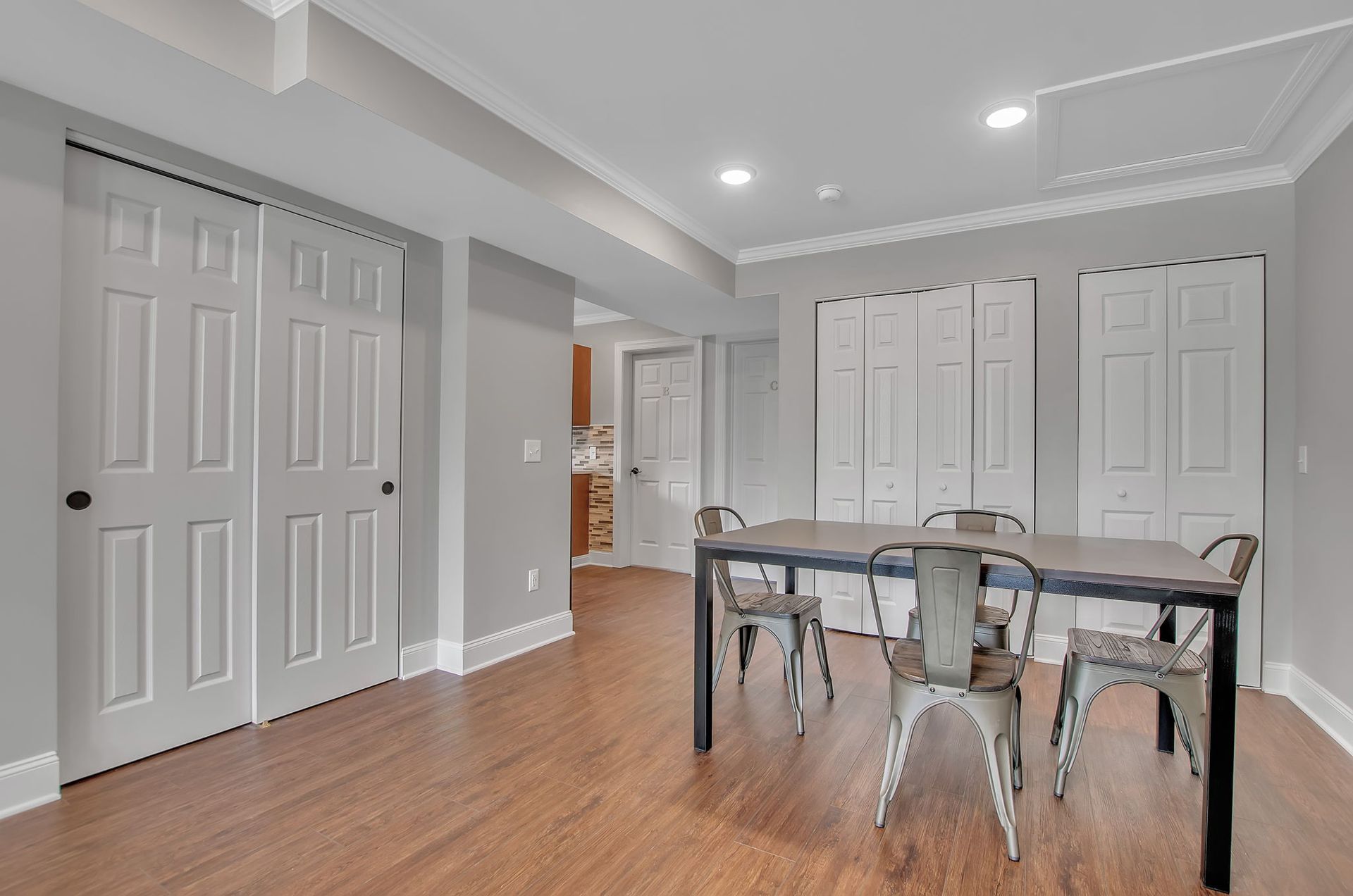 A dining room with a table and chairs in a basement.