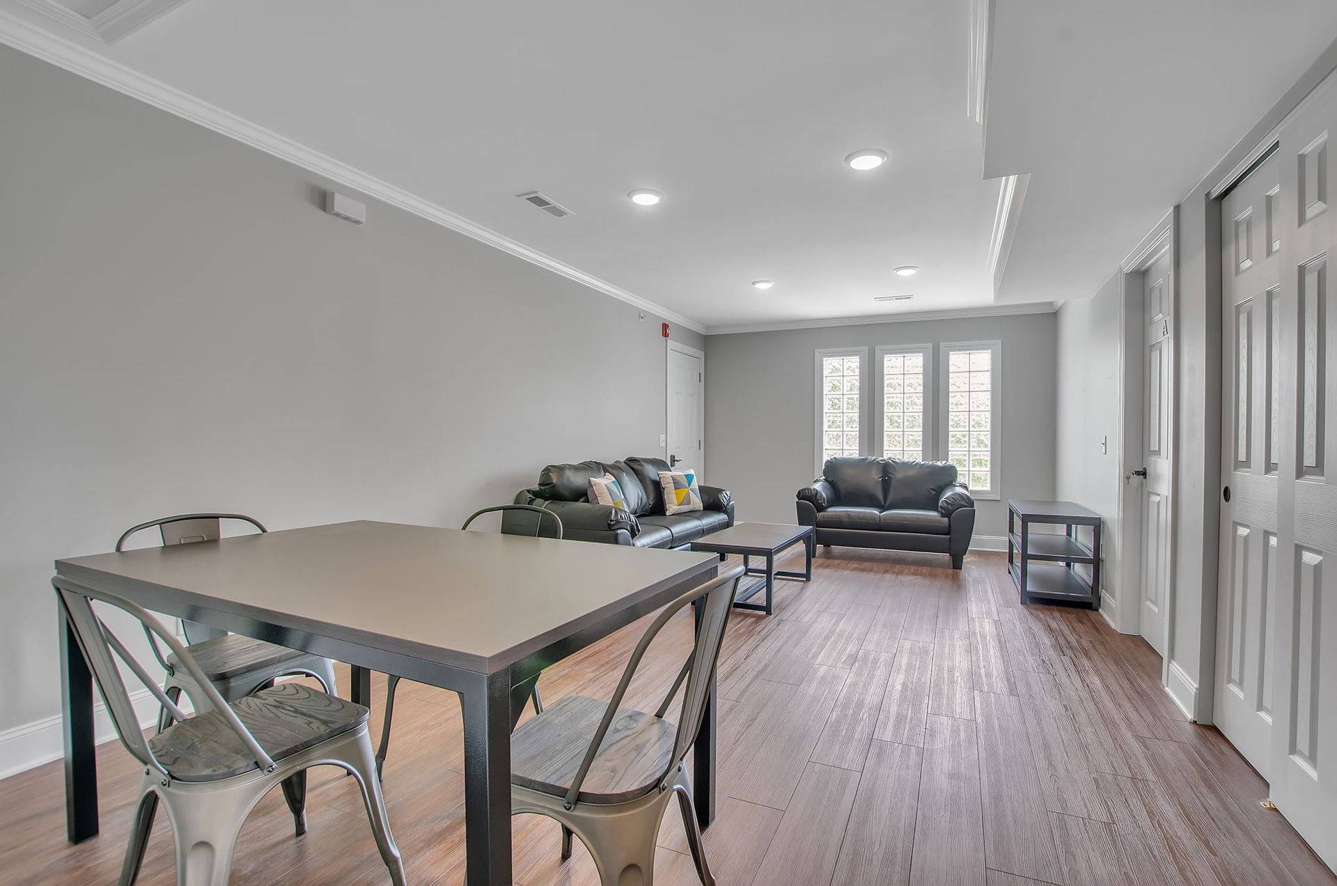 A living room with a table and chairs and a couch.