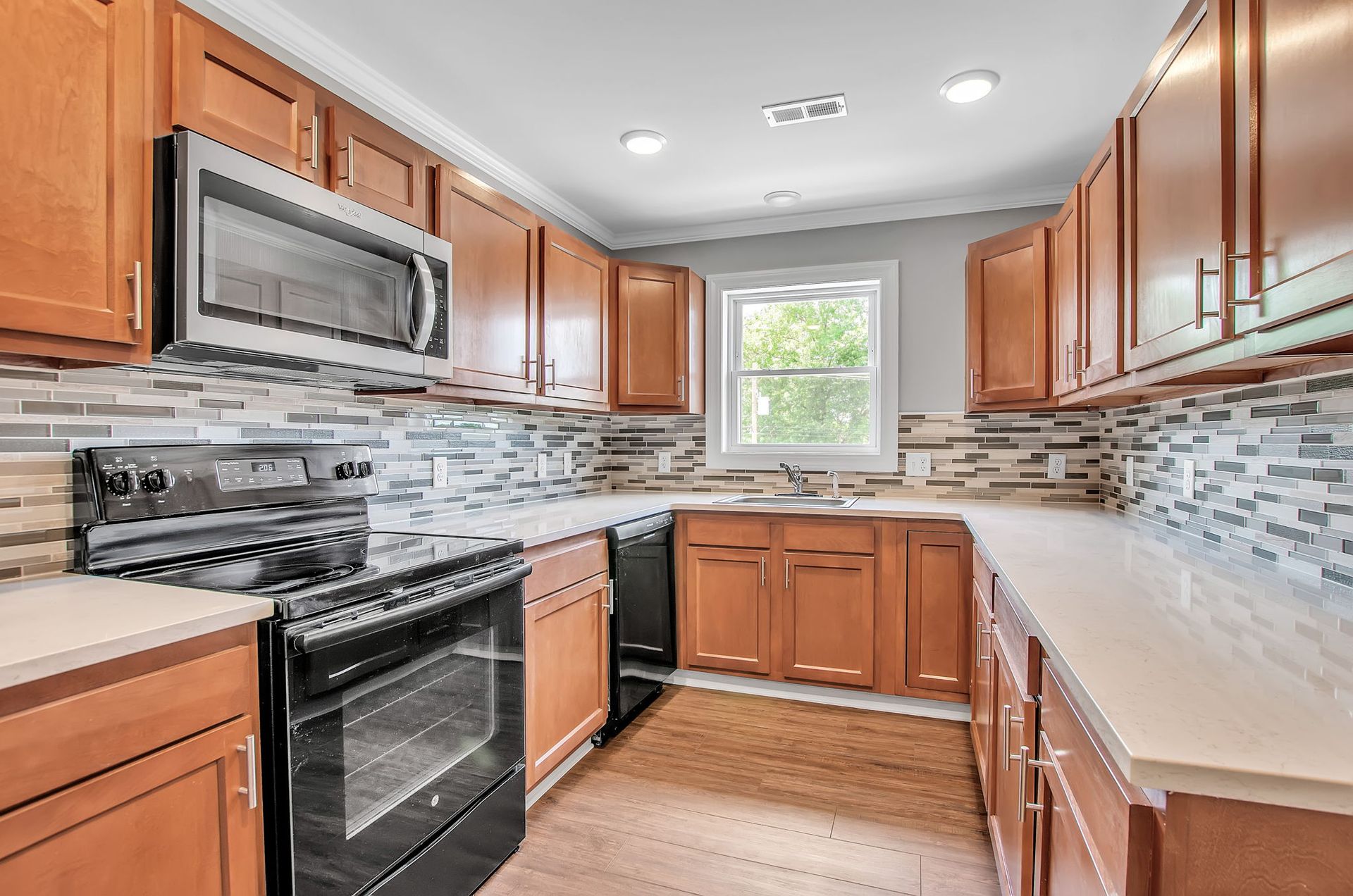 A kitchen with wooden cabinets and stainless steel appliances.