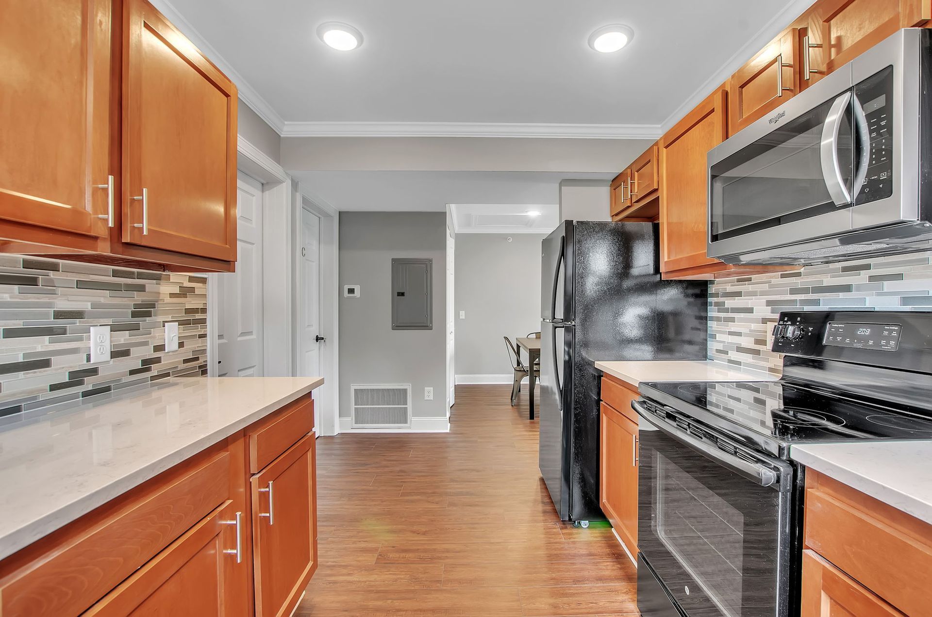 A kitchen with stainless steel appliances and wooden cabinets