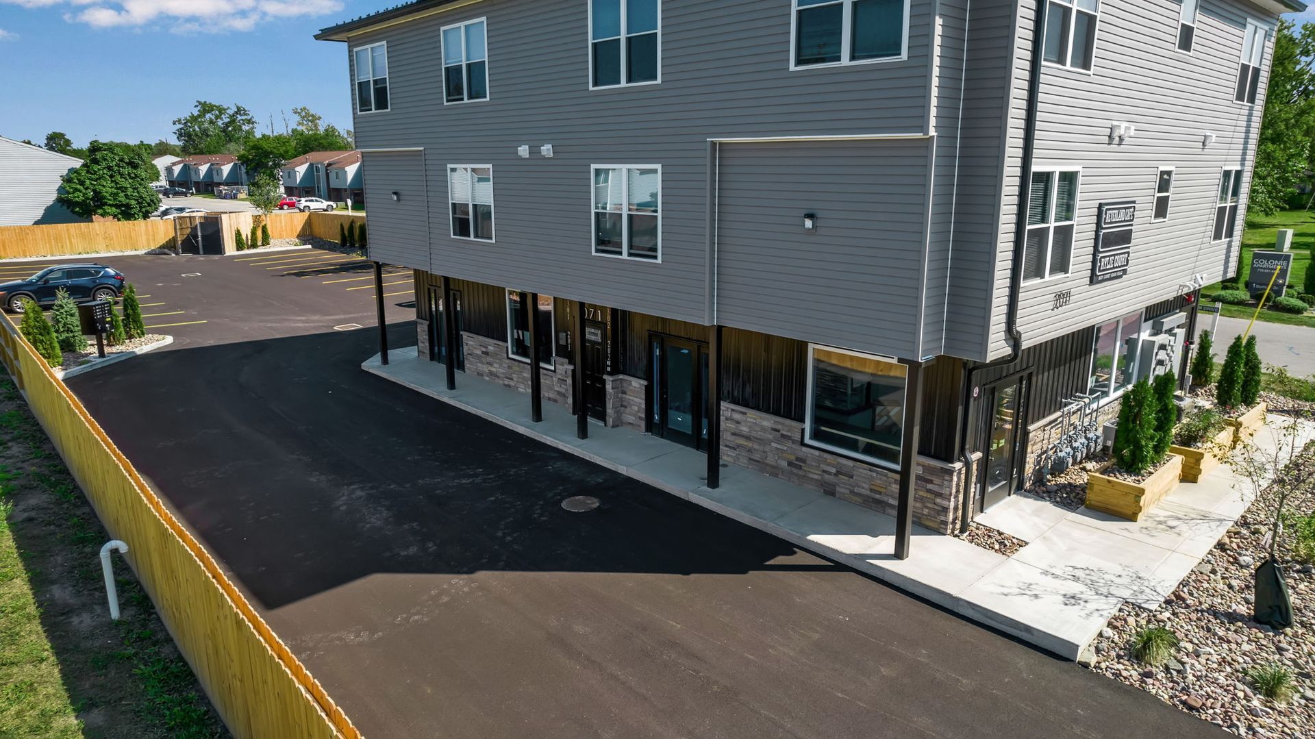 rone image showing apartment buildings arranged around parking areas