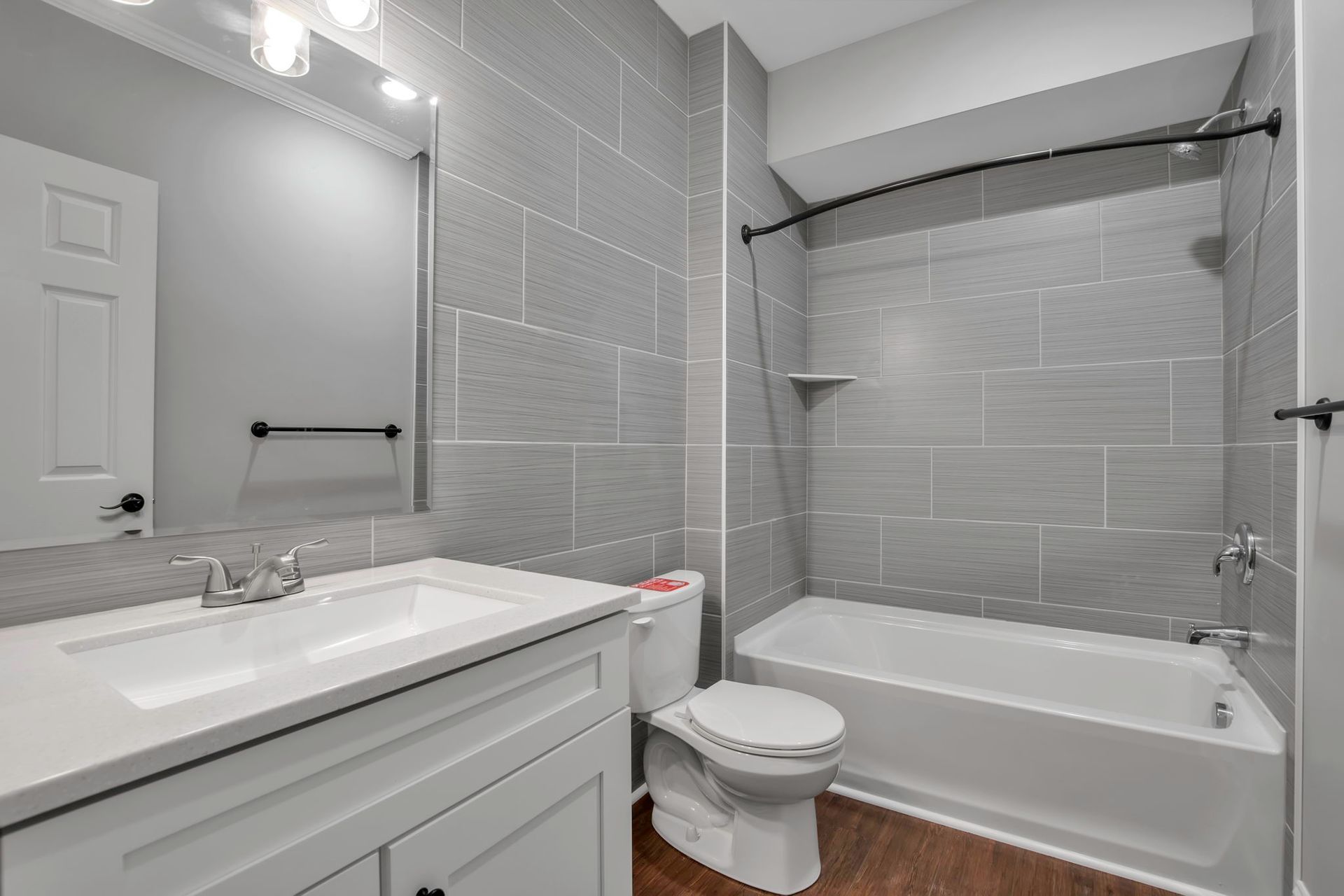 Wash area featuring sleek tile finish and vanity