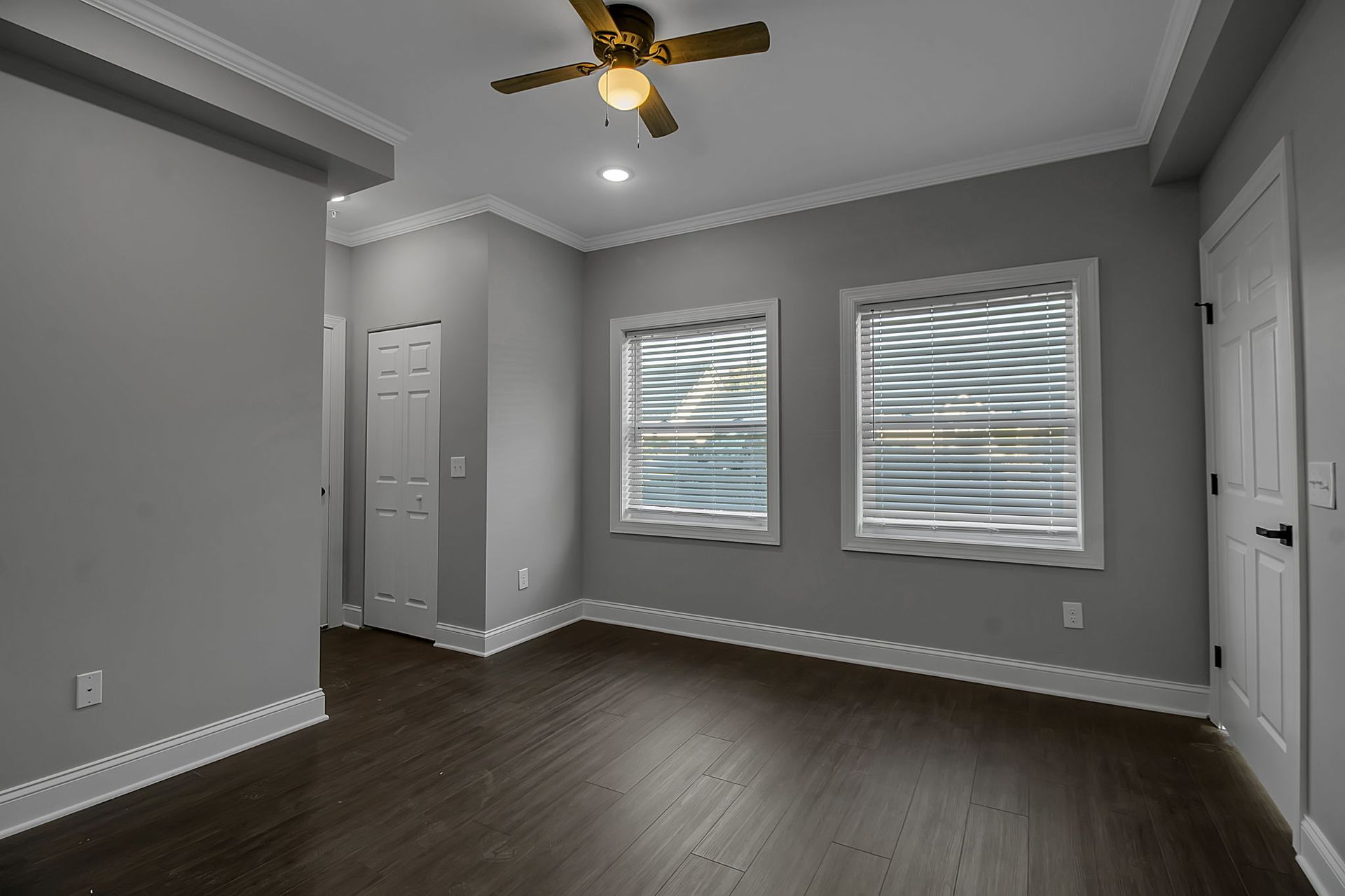 Bedroom interior featuring polished flooring and trim accents