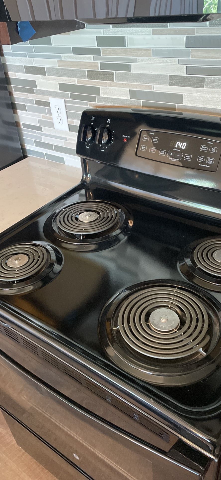 A stove top oven is sitting on top of a counter in a kitchen.