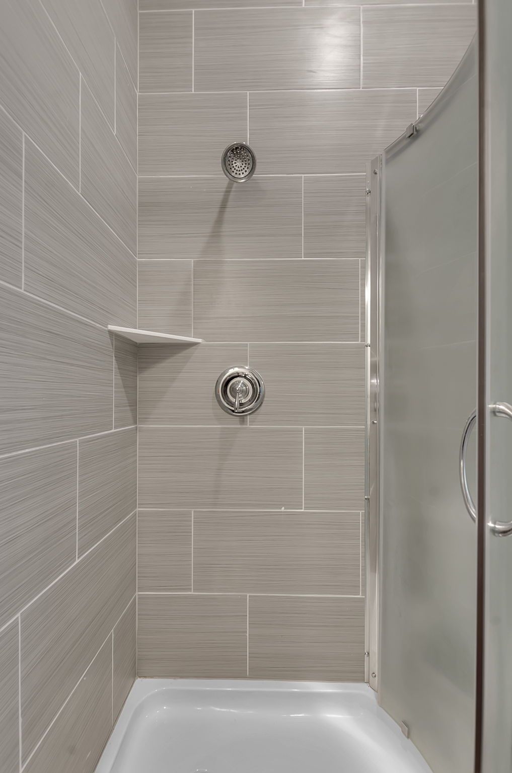 A bathroom with a shower and a bathtub.
