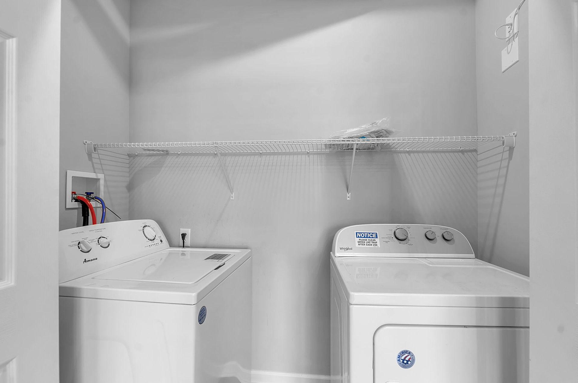 A laundry room with a washer and dryer in it.