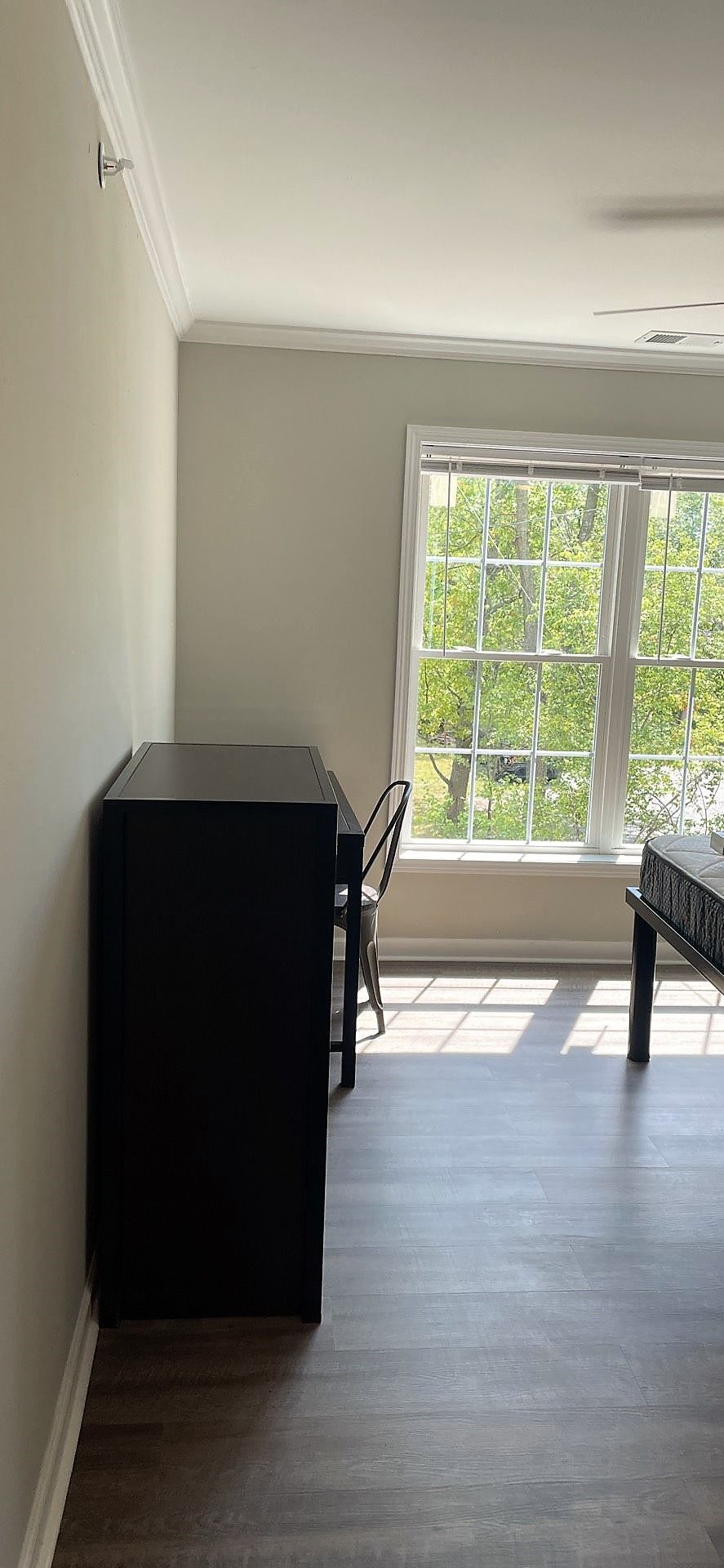 A living room with a table and chairs and a large window.