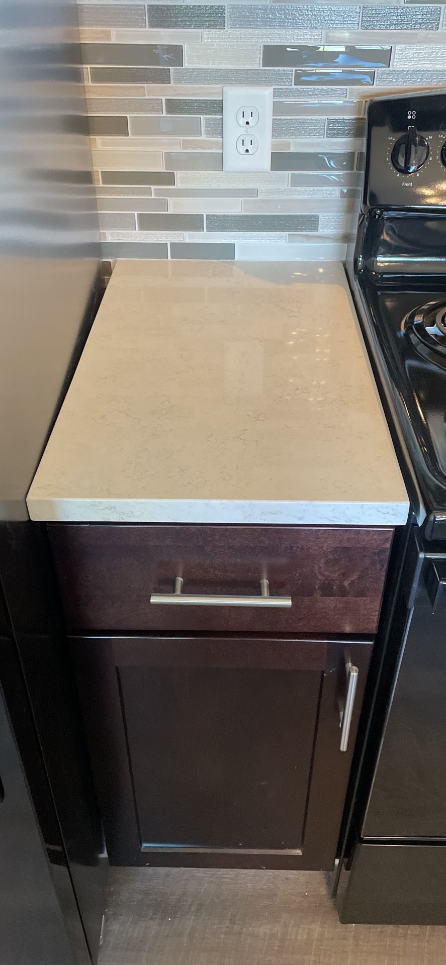 A kitchen with a stove and a counter top.