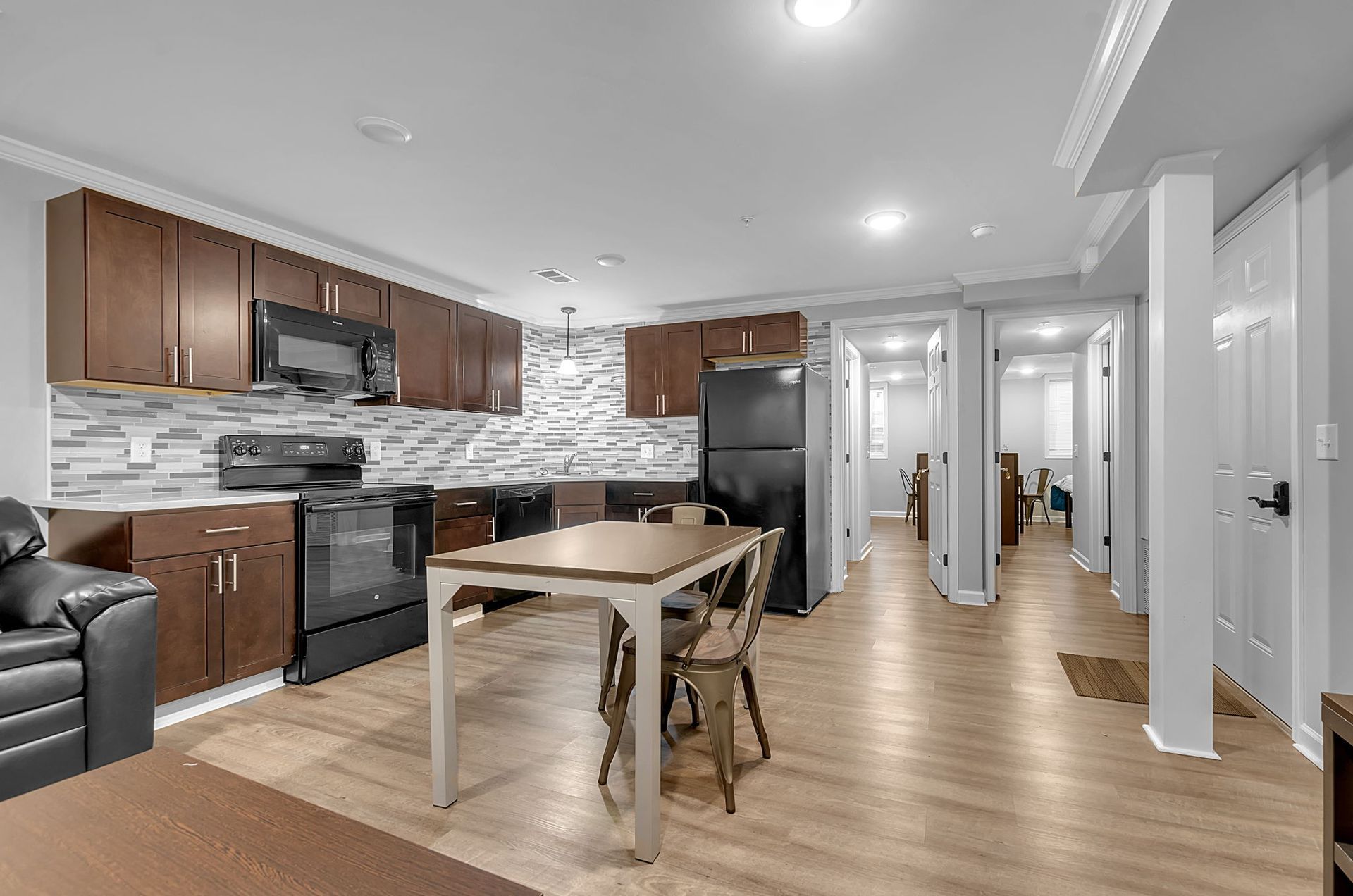 A kitchen with a table and chairs in it.