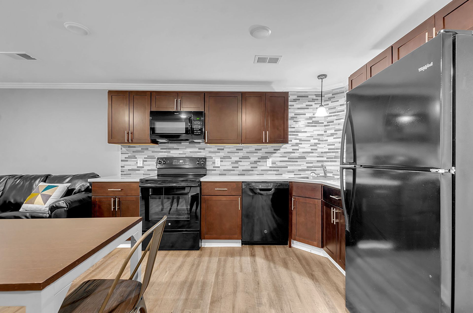 A kitchen with stainless steel appliances and wooden cabinets.