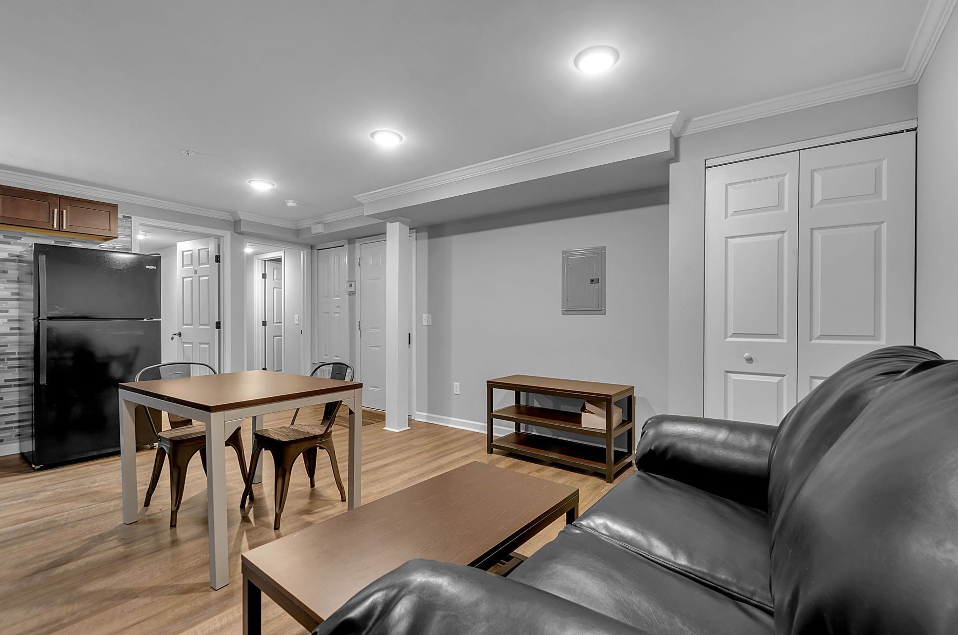 A living room with a couch , table and chairs.