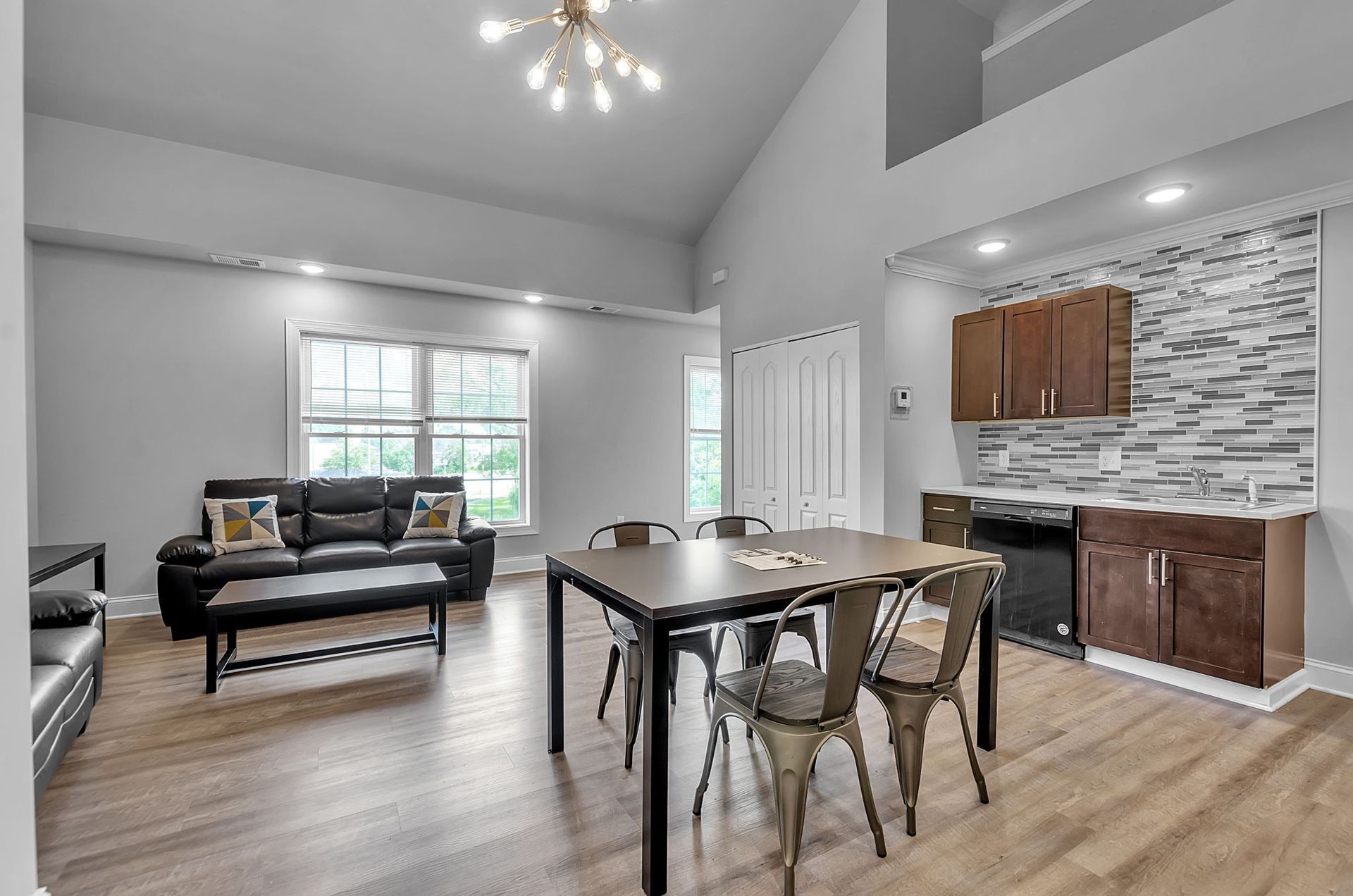 A living room with a dining table and chairs and a couch.