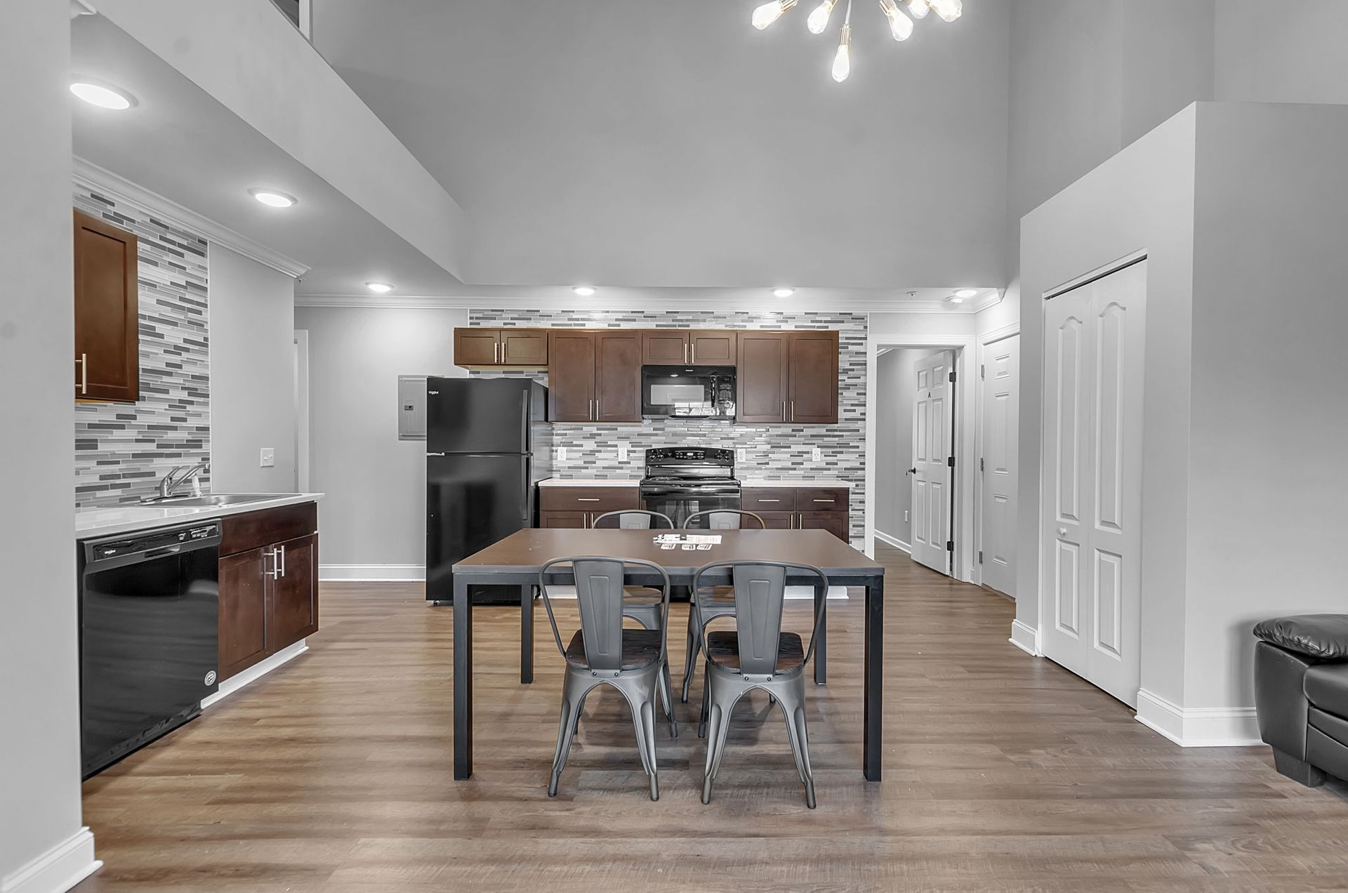 A kitchen and dining room in a house with a table and chairs.