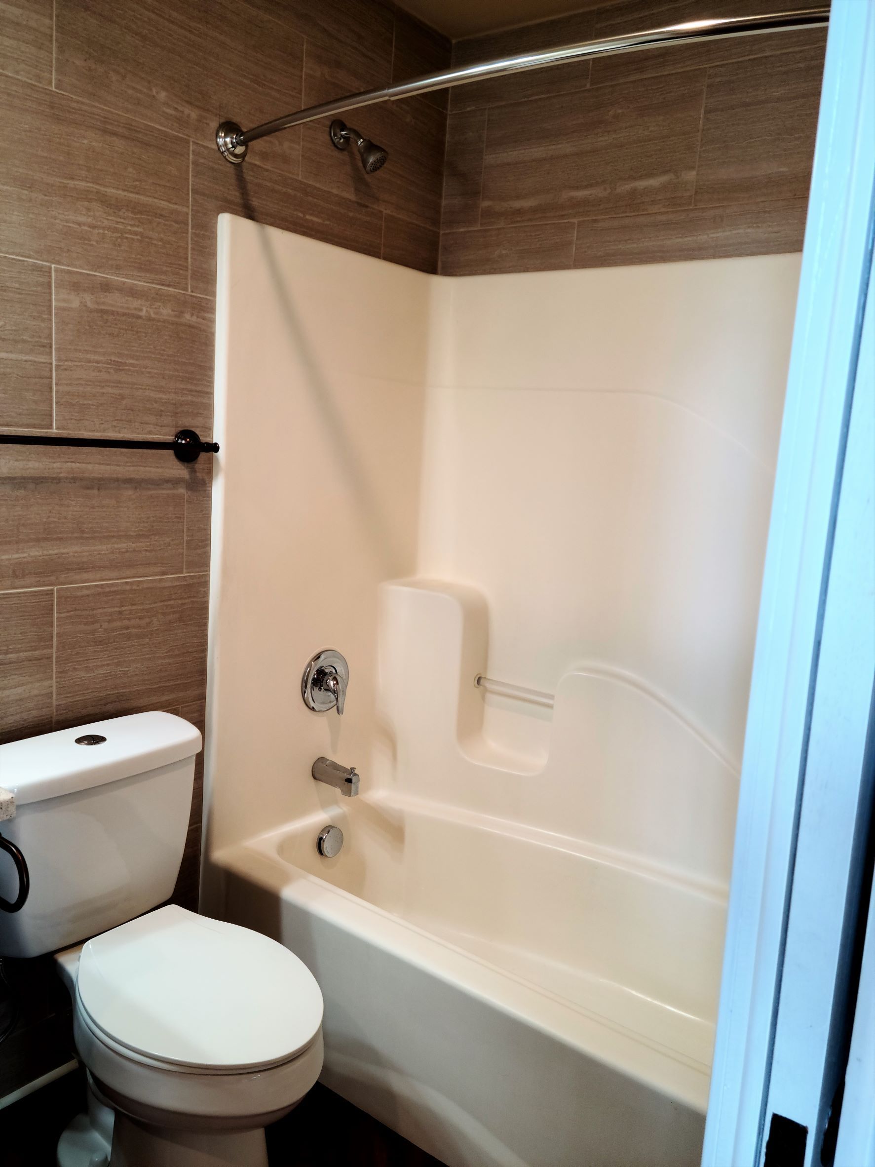A bathroom with a toilet a bathtub and a shower