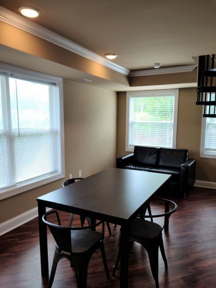 A living room with a table and chairs and a couch