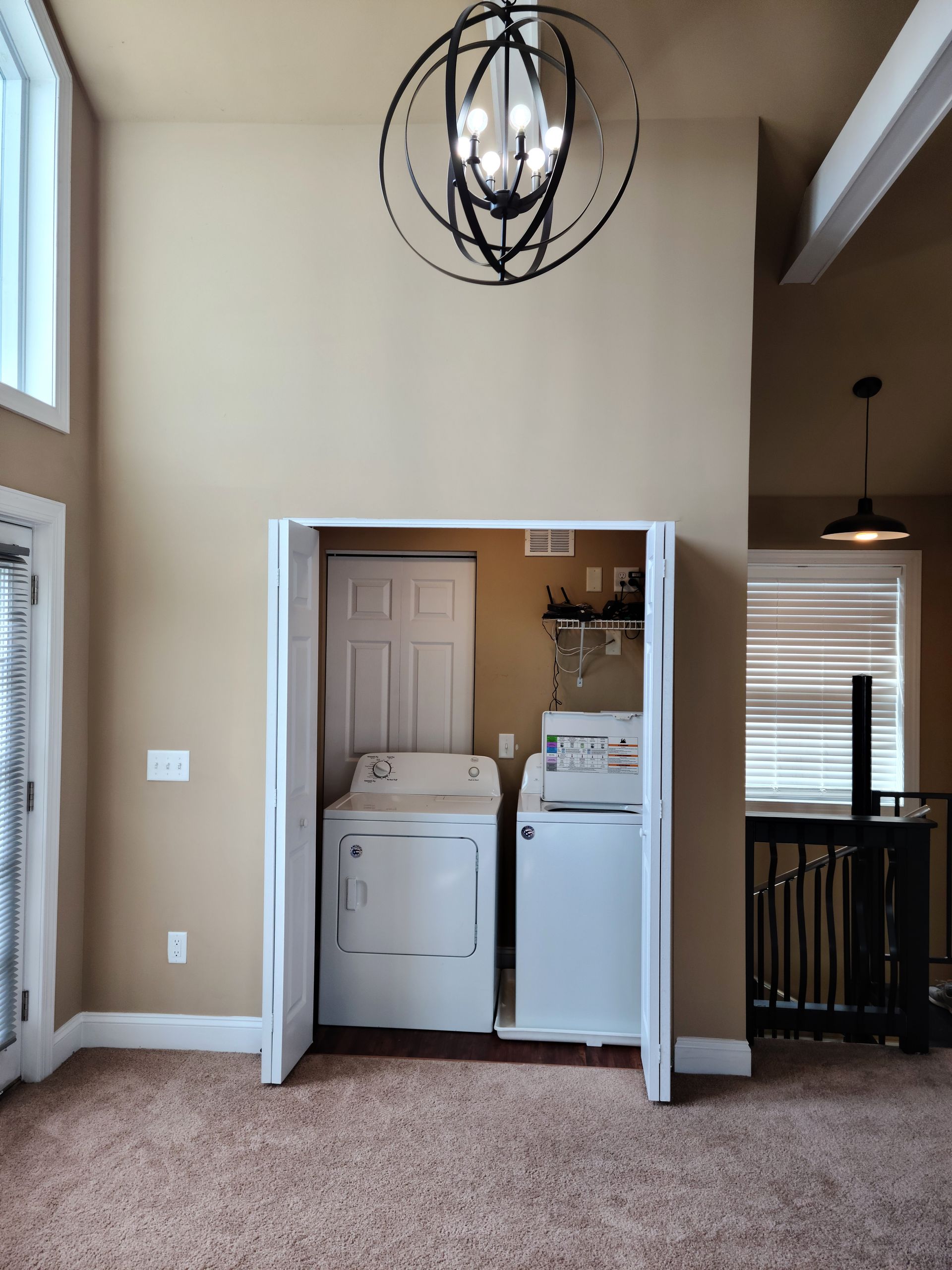 A laundry room with a washer and dryer in a closet