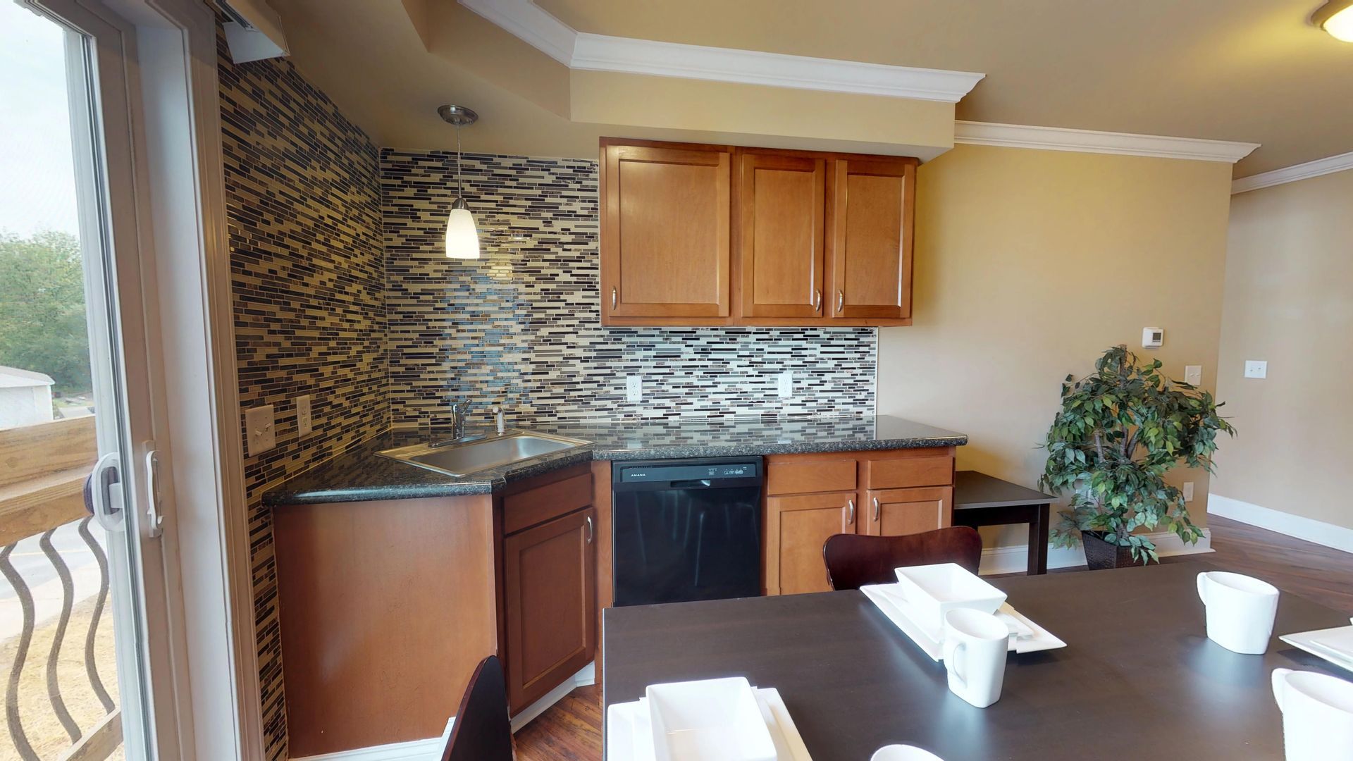 A kitchen with a table and chairs and a sink
