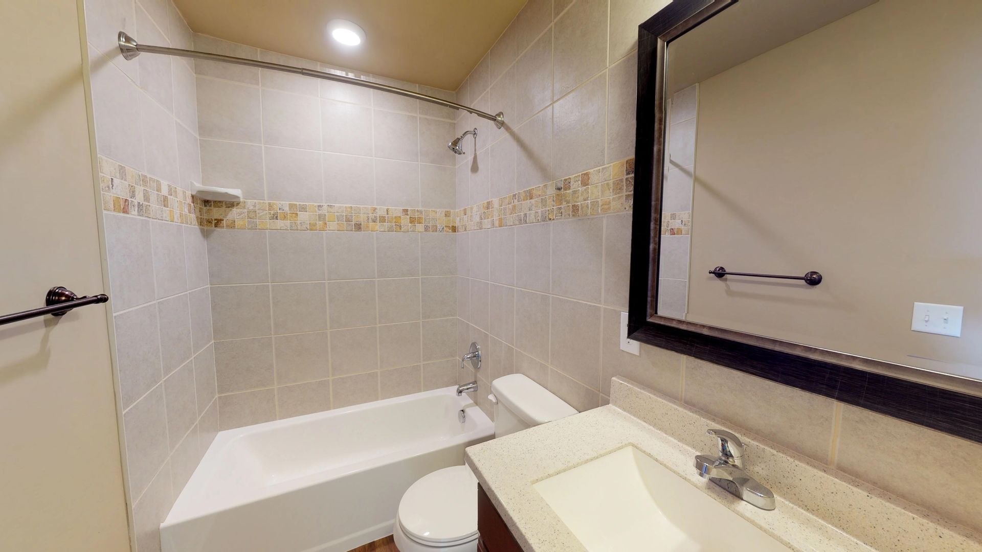 A bathroom with a sink , toilet , bathtub and mirror.