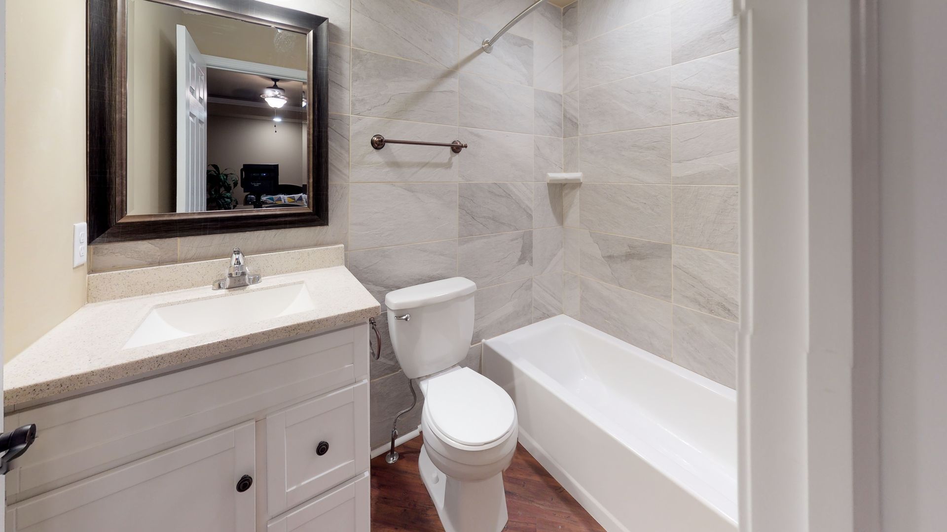 A bathroom with a toilet , sink , and bathtub.
