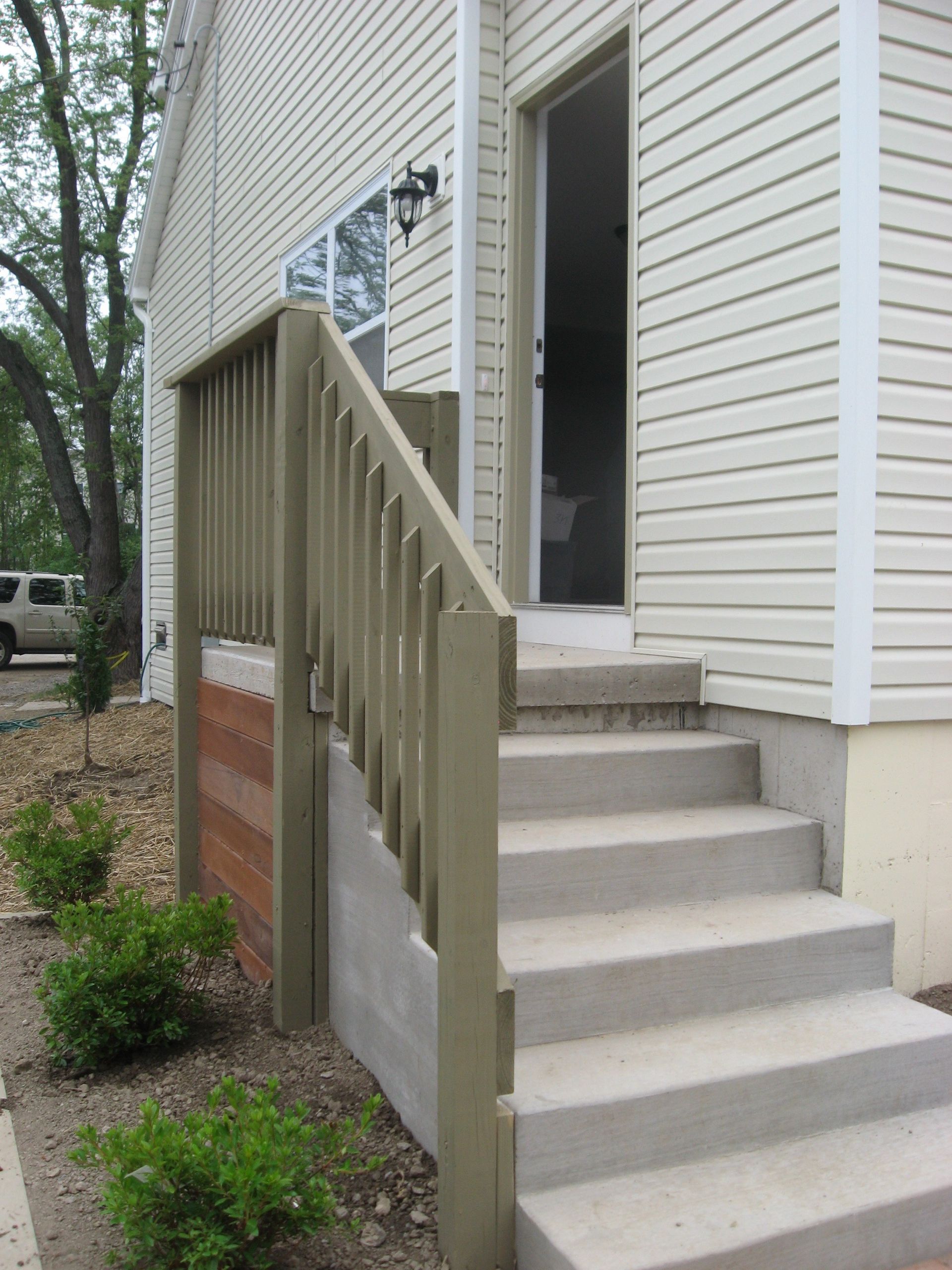 A house with stairs leading up to the front door