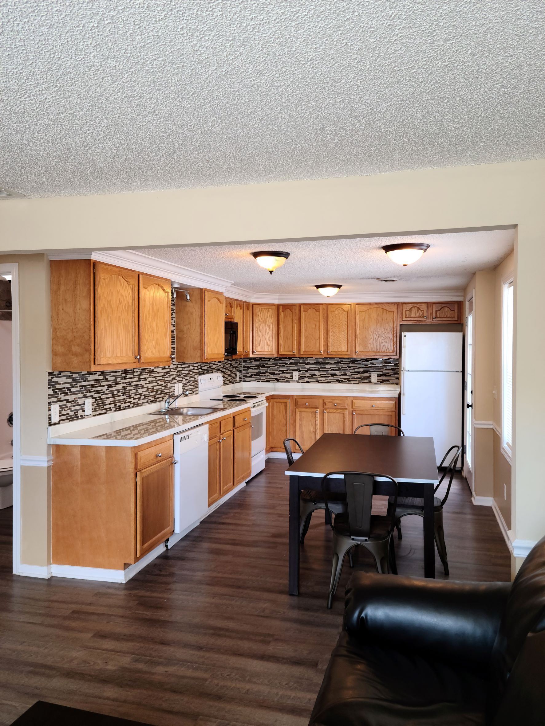 A kitchen with a table and chairs in it