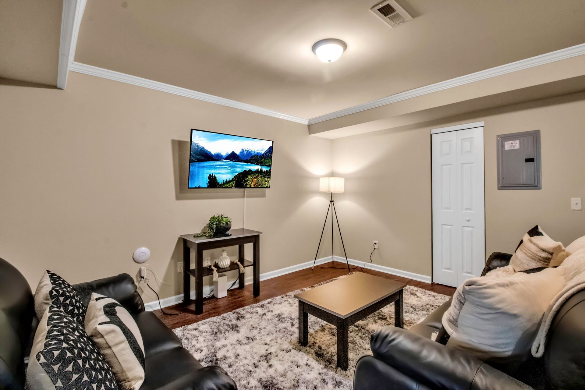 A living room with a couch , table , and television.