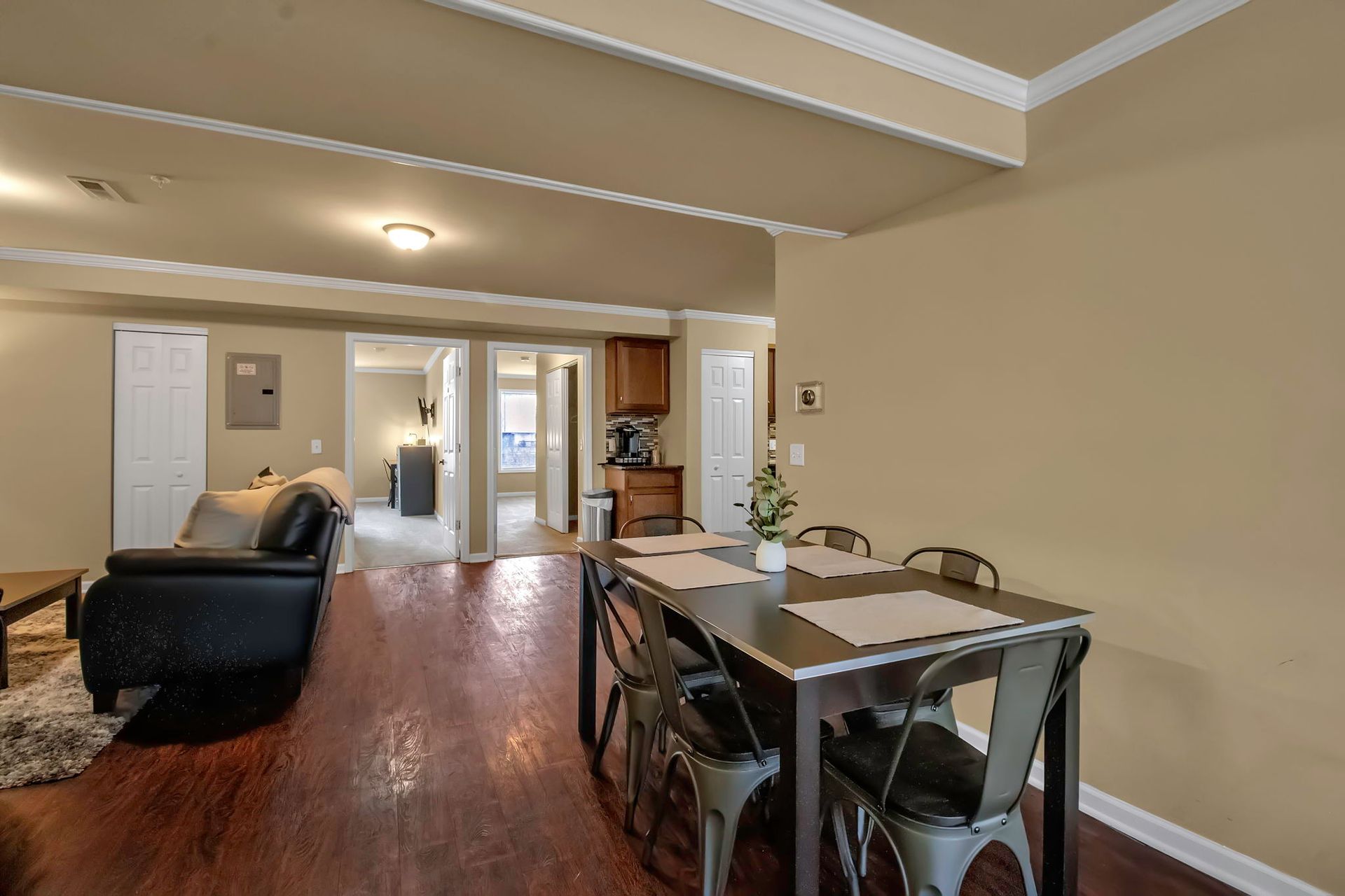 A living room with a dining table and chairs and a couch.