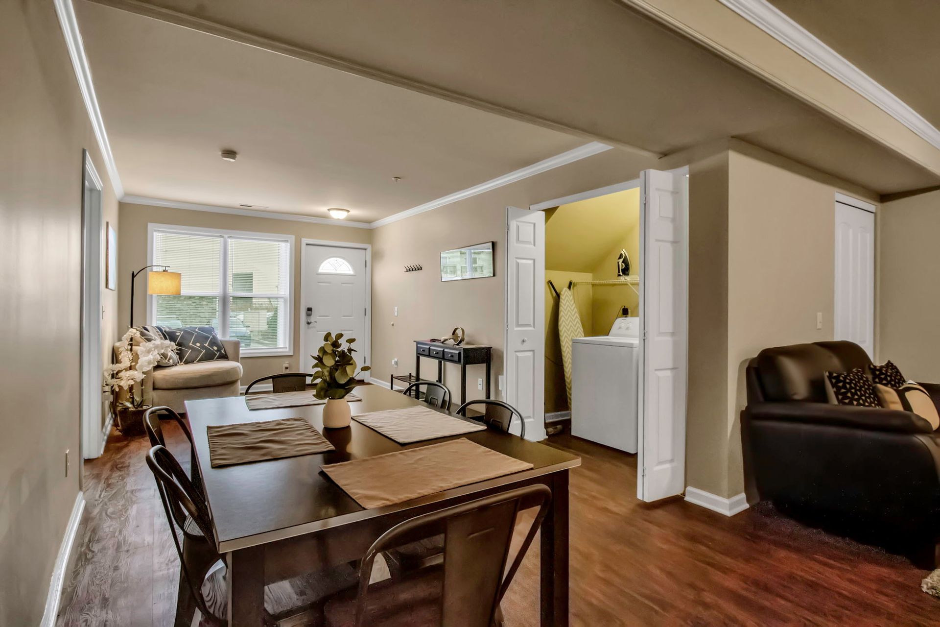 A living room with a dining table and chairs and a couch.