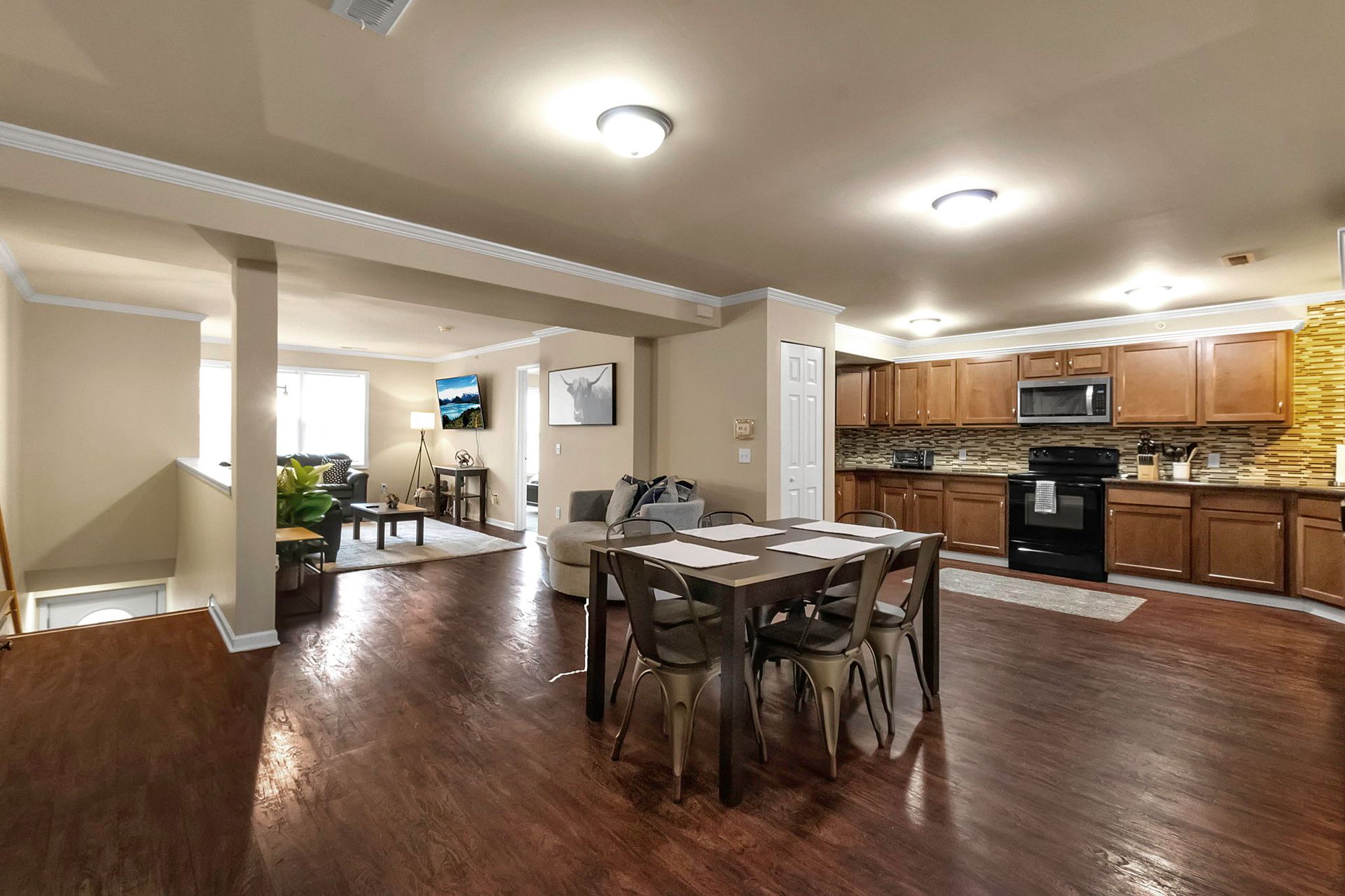 There is a dining table and chairs in the middle of the room.
