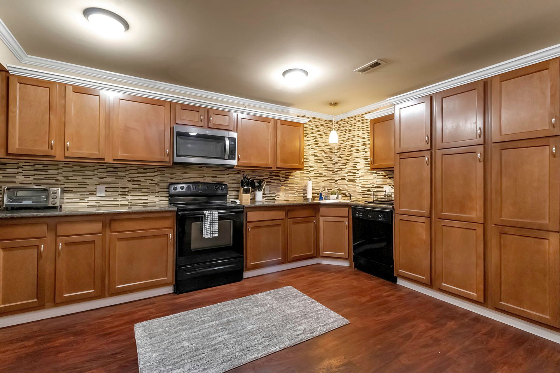 A kitchen with wooden cabinets and stainless steel appliances