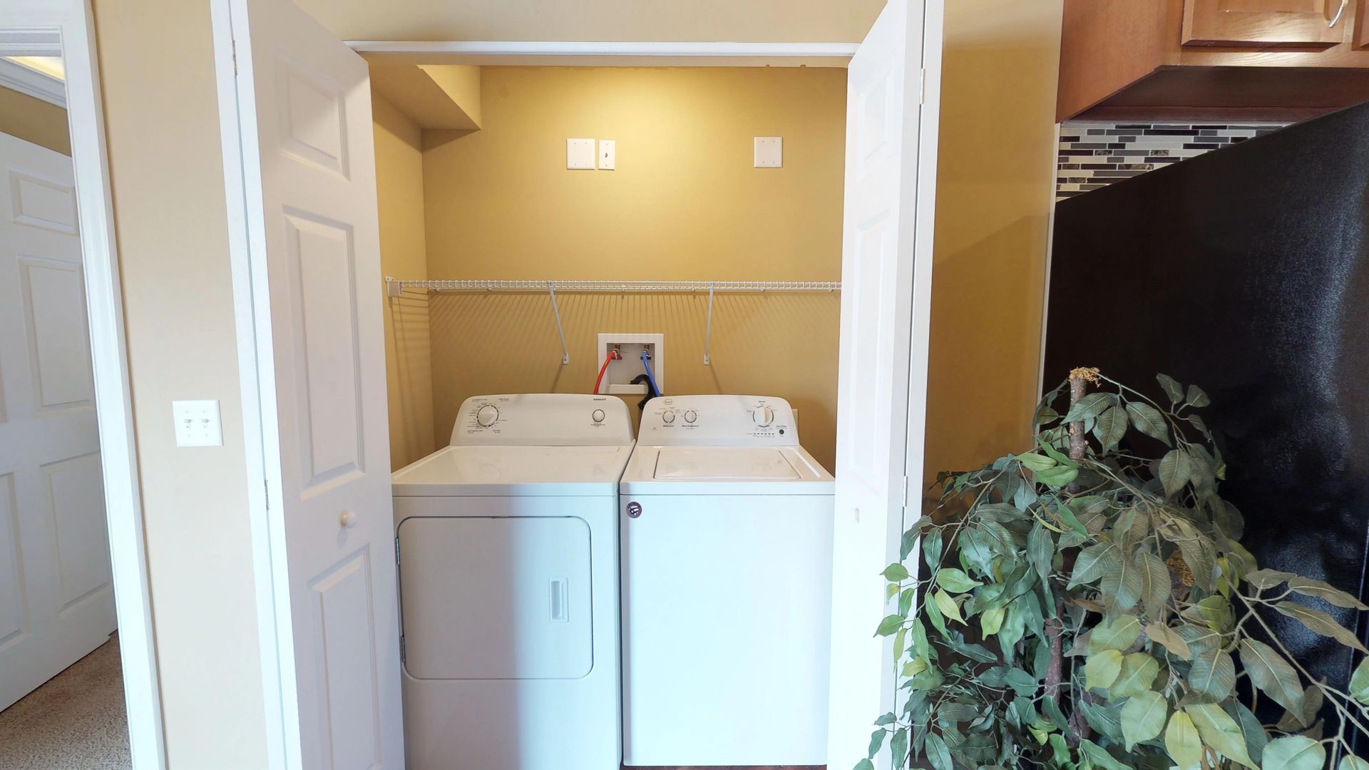 A laundry room with a washer and dryer in it.