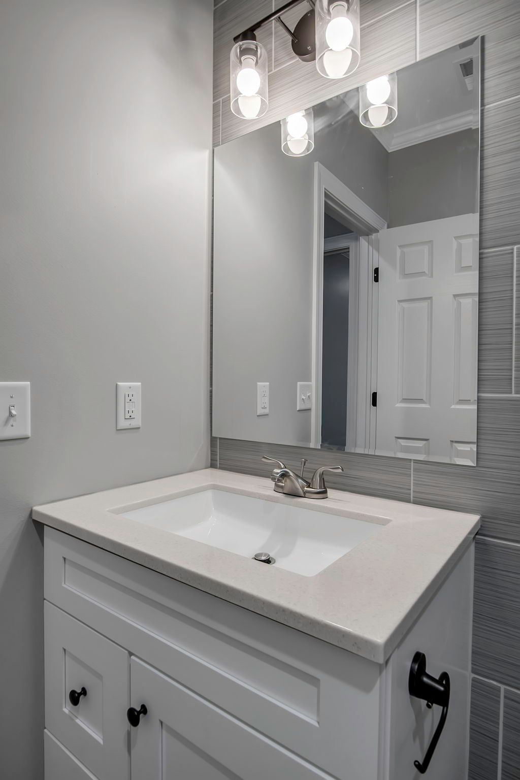 Bathroom space with polished plumbing fixtures and mirror