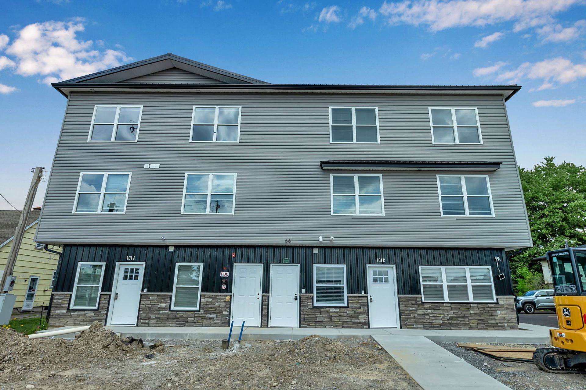 Exterior shot of apartment buildings with walkways and landscaping